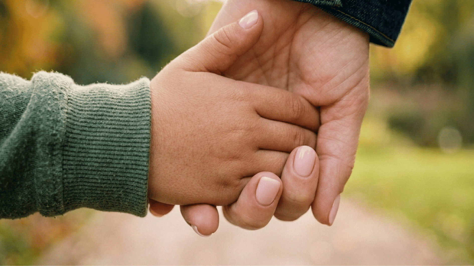 a closeup of holding hands of a mother and her son