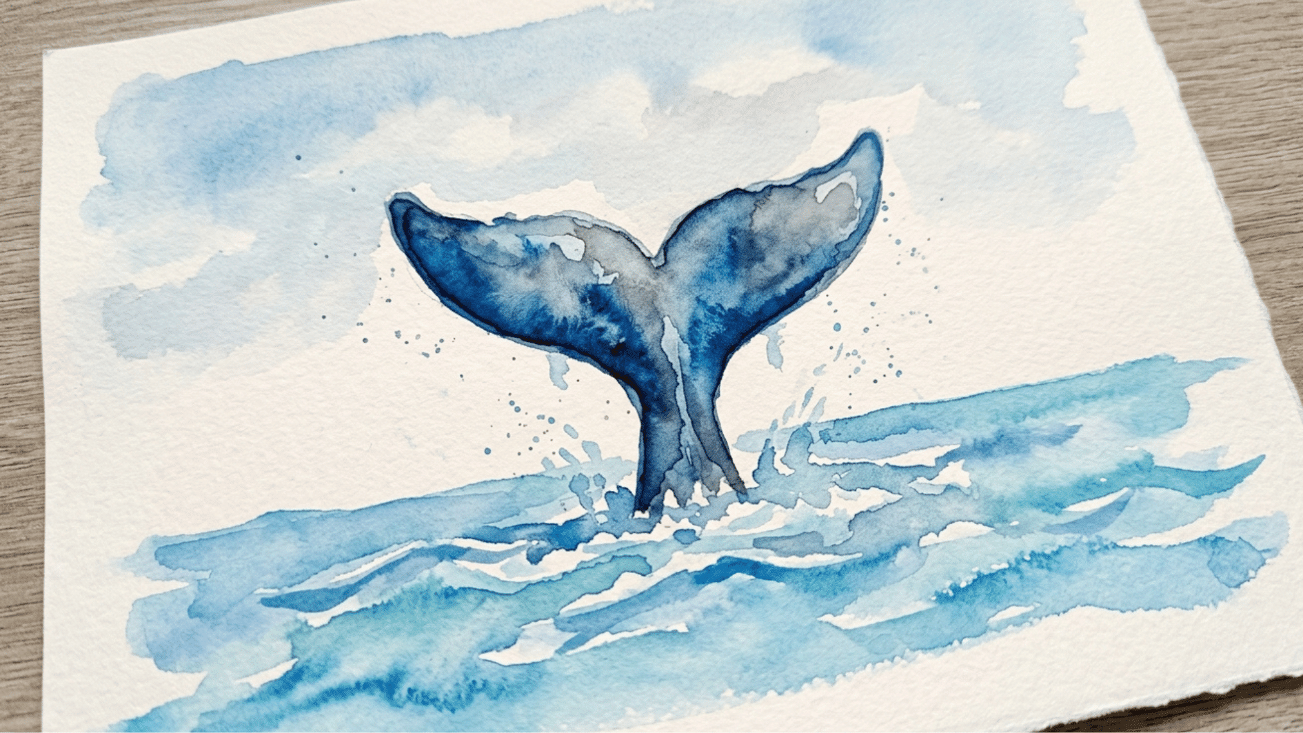 majestic whale tail painting rising above gentle blue waves in a peaceful ocean inspired scene
