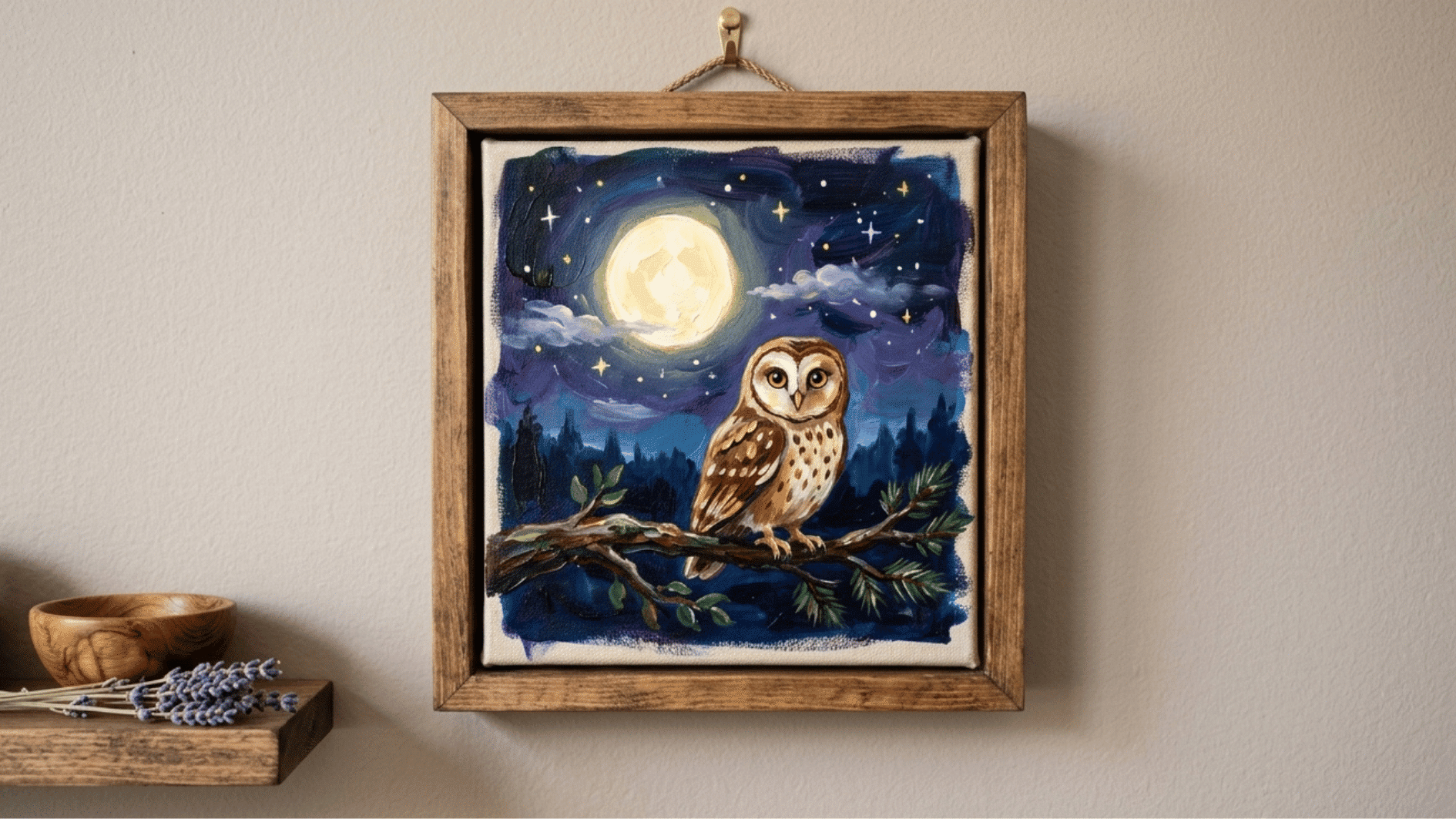 a canvas painting of owl under a full moon hung on the wall