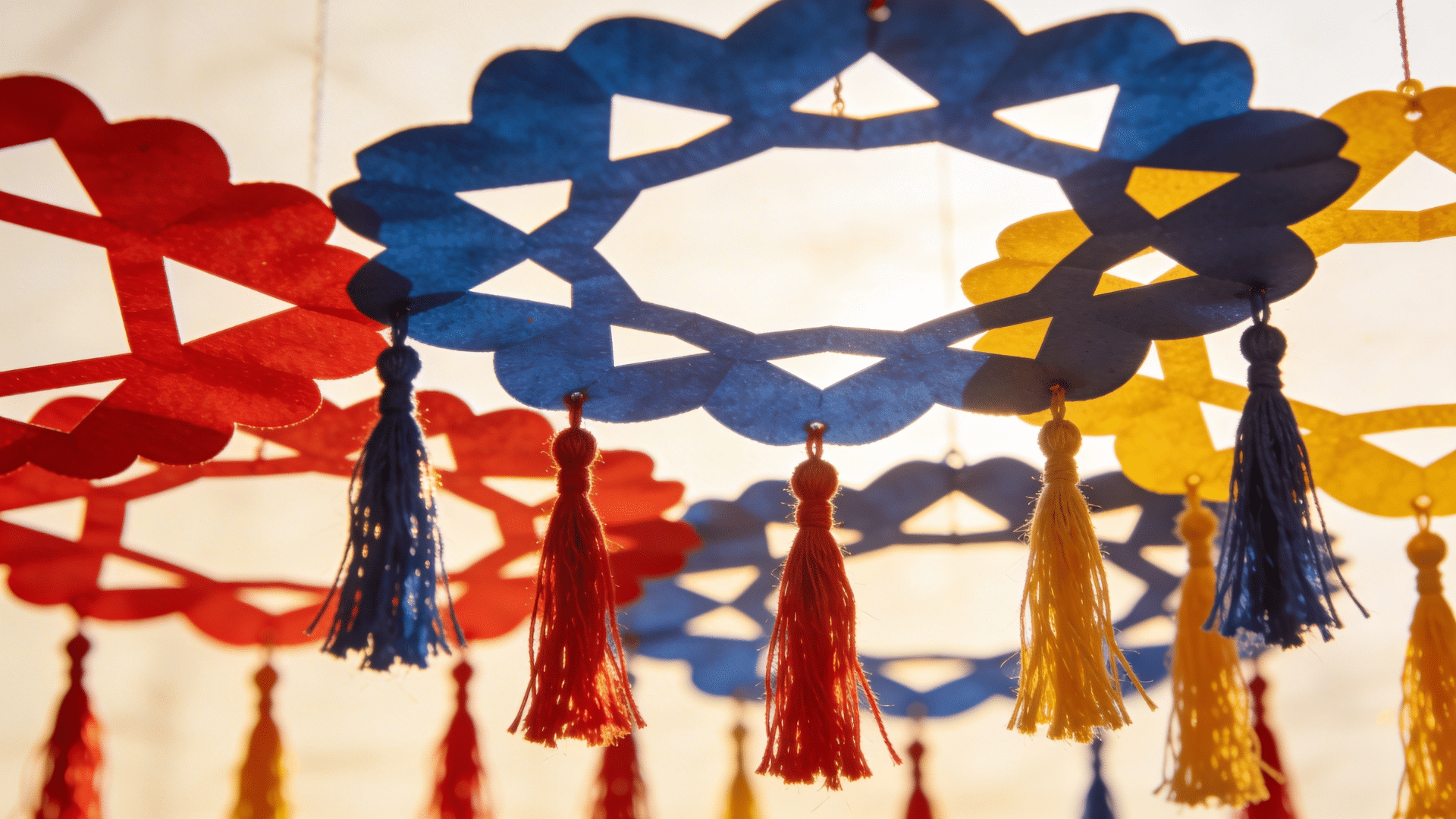 paper medallion decorations hanging from the ceiling with layered folded designs adding festive color to the space.