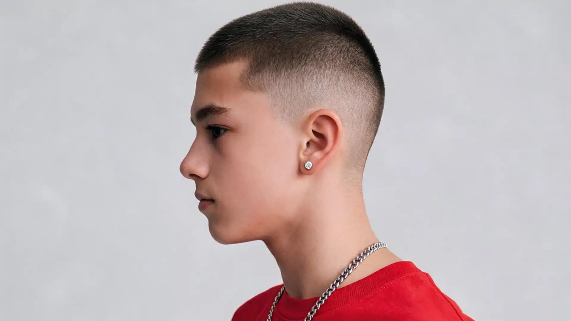 side profile of a boy with a buzz cut featuring evenly clipped hair and a clean high fade on the sides