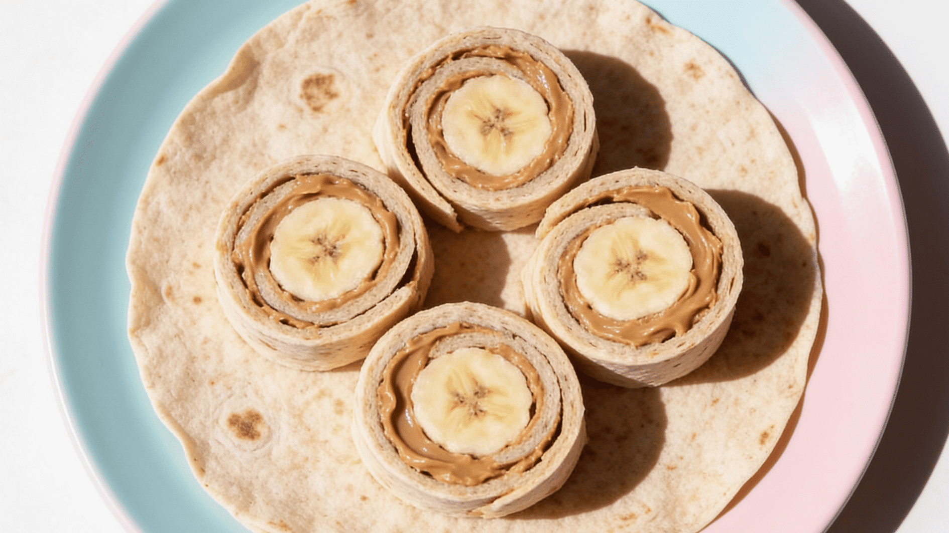 _soft whole-grain tortilla rolled around banana with nut butter