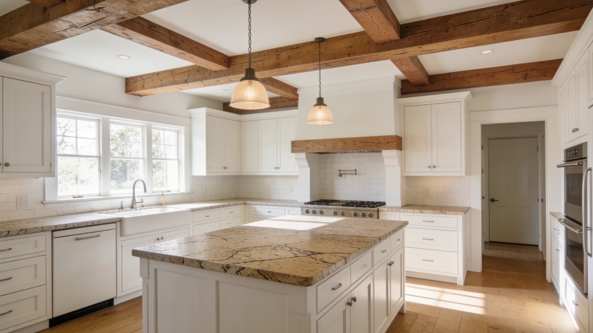 spacious farmhouse kitchen with exposed wood beams warm white cabinets stone counters and large island