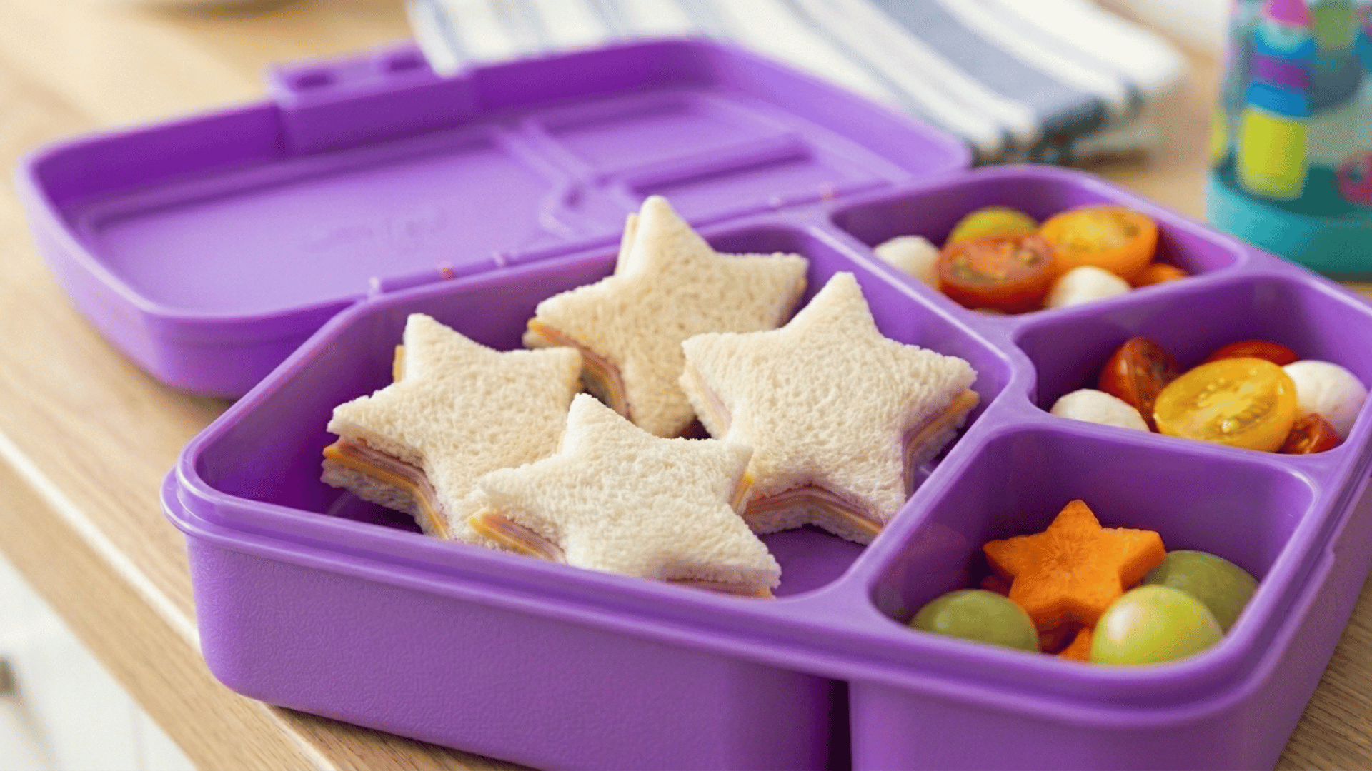 star-shaped ham sandwiches packed in a purple plastic lunchbox