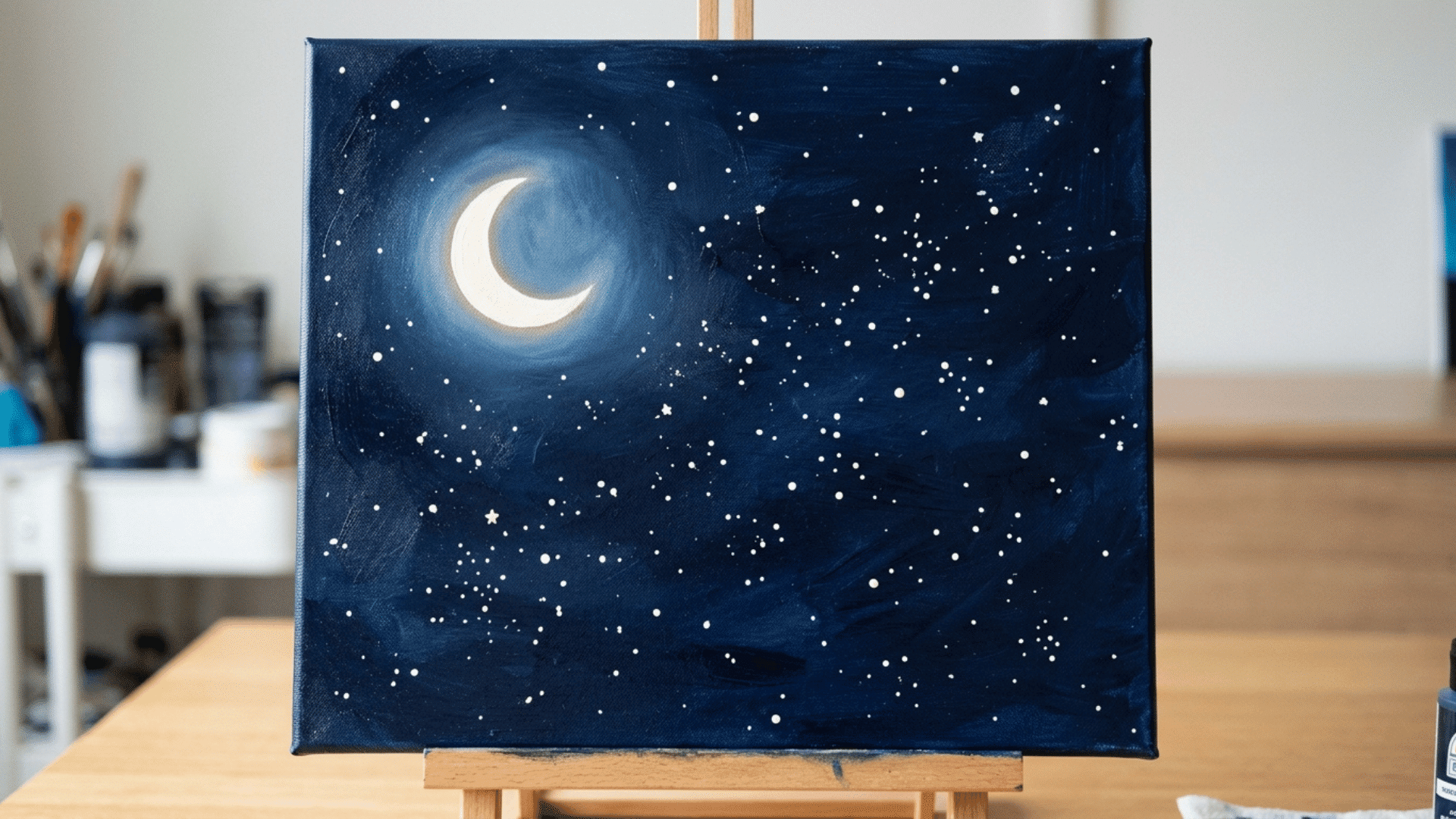 starry night sky with a glowing crescent moon