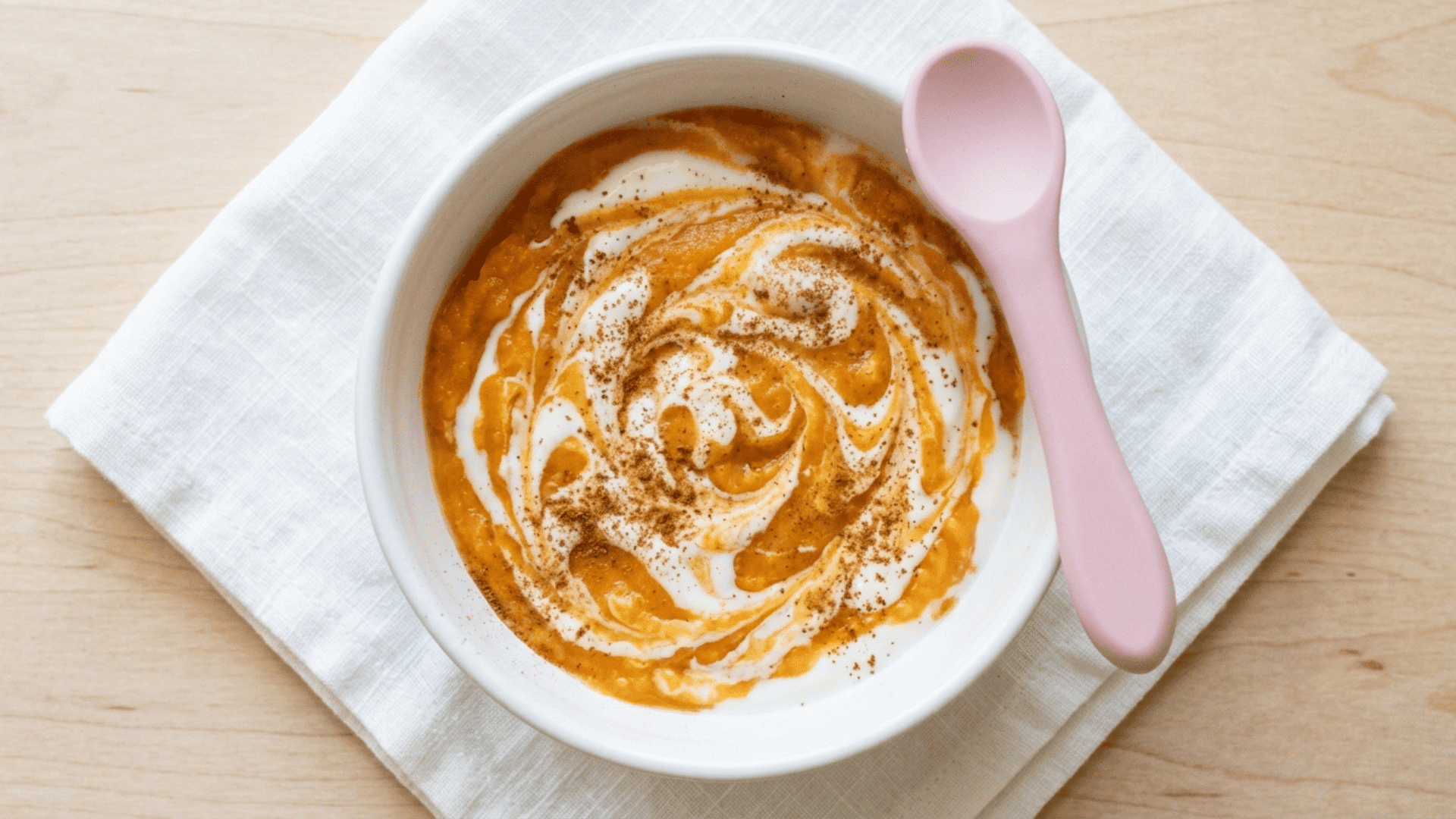 sweet potato and yogurt swirl in a white baby bowl