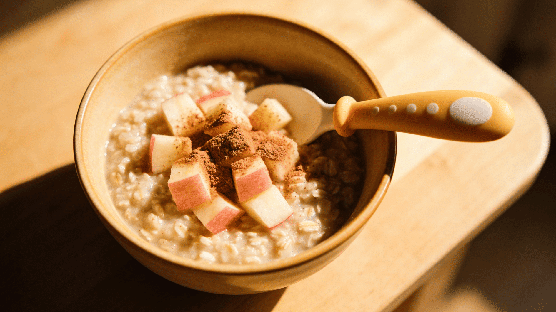 warm bowl of oatmeal with grated apple and cinnamon