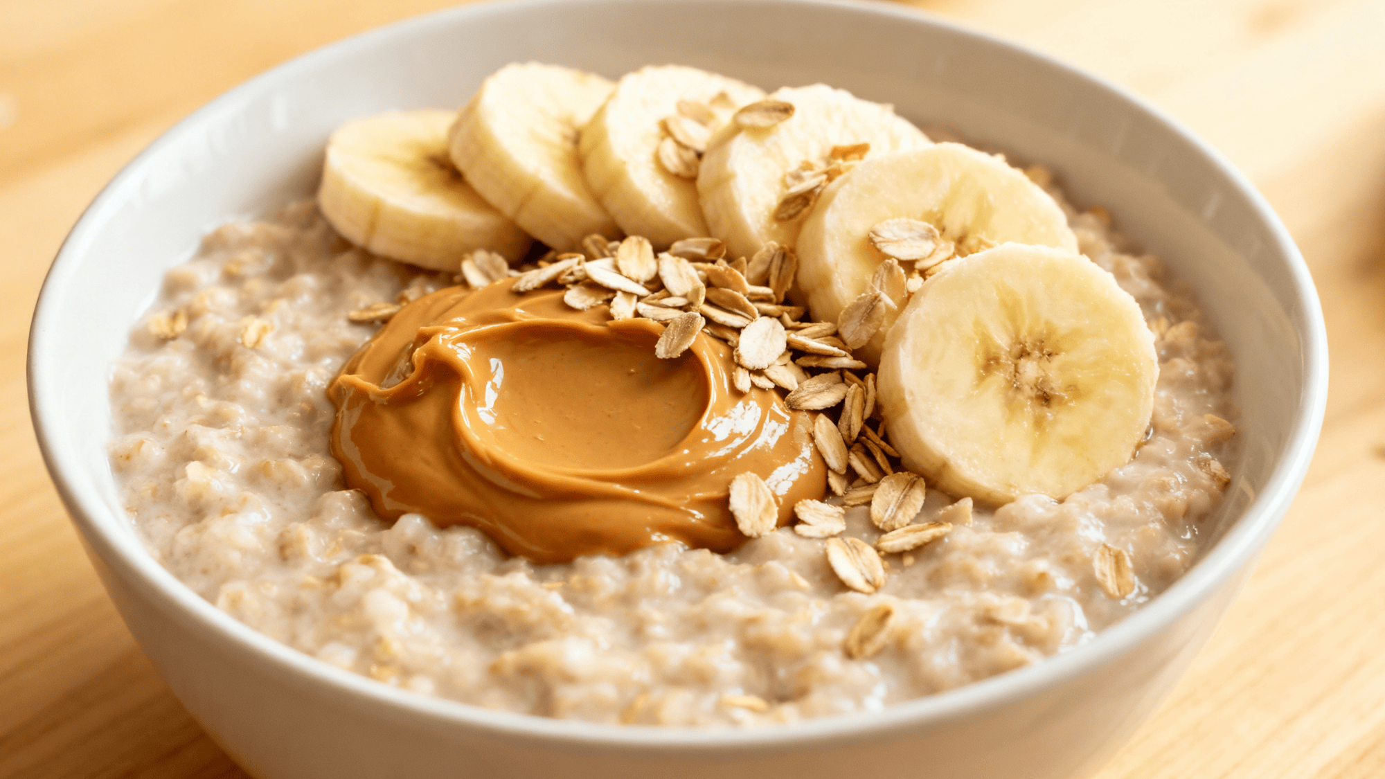 warm bowl of peanut butter banana oatmeal, caramelized banana slices, swirl of peanut butter, chia seeds