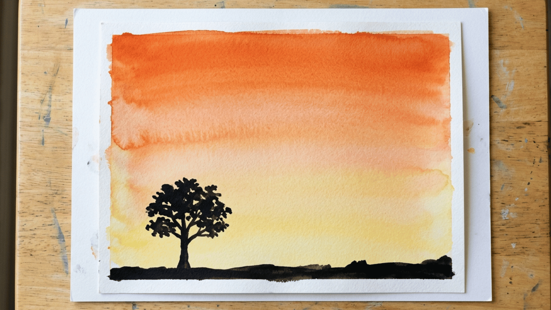 child made watercolor ombre sky painting with tree silhouette