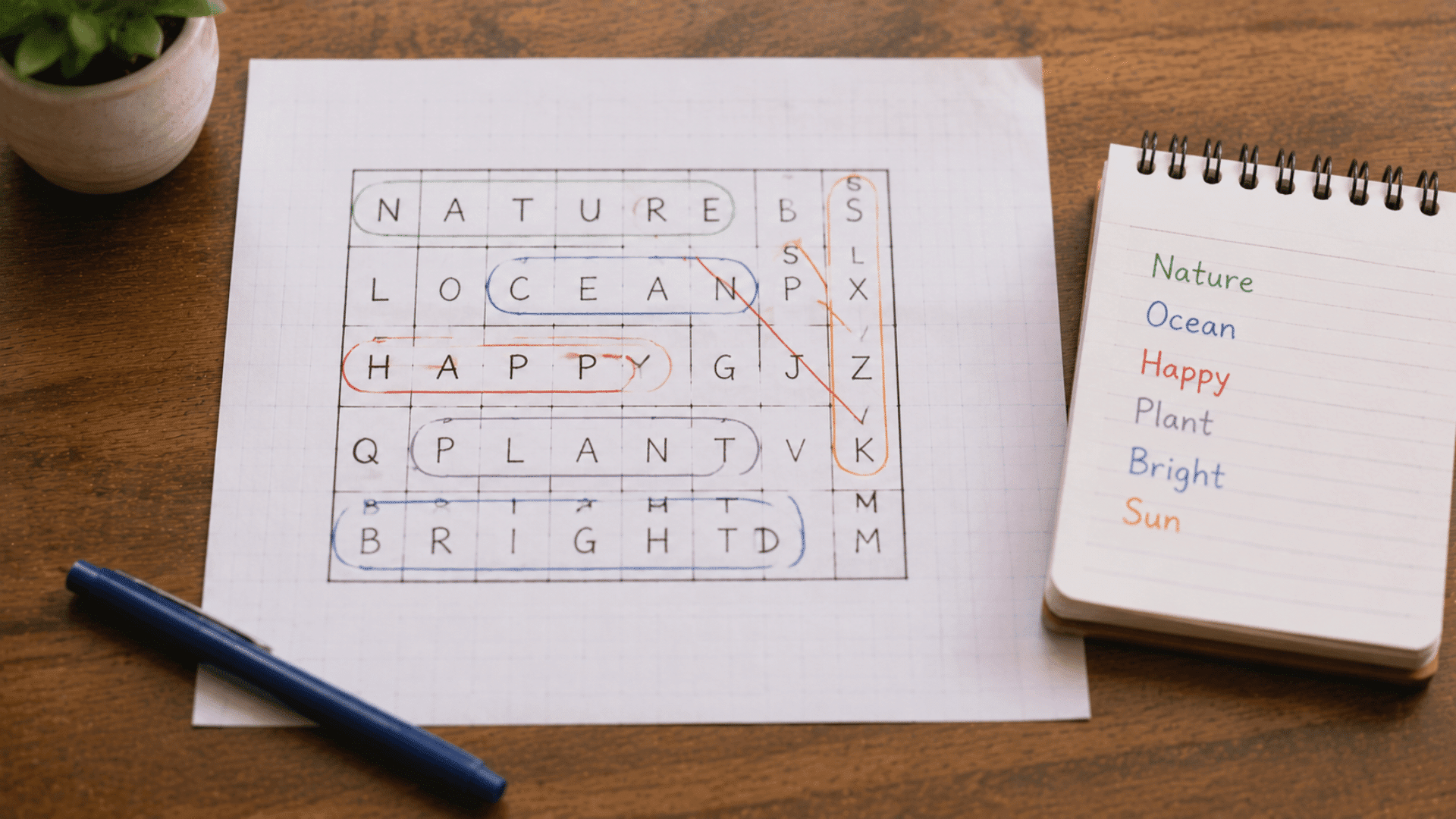 word search puzzle on grid paper next to a small notepad listing the words to find