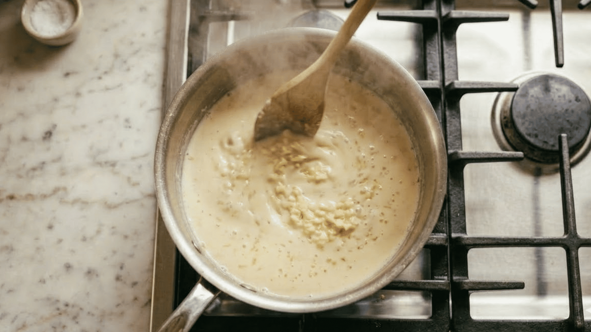 minced garlic stirred into warm cream for homemade alfredo sauce