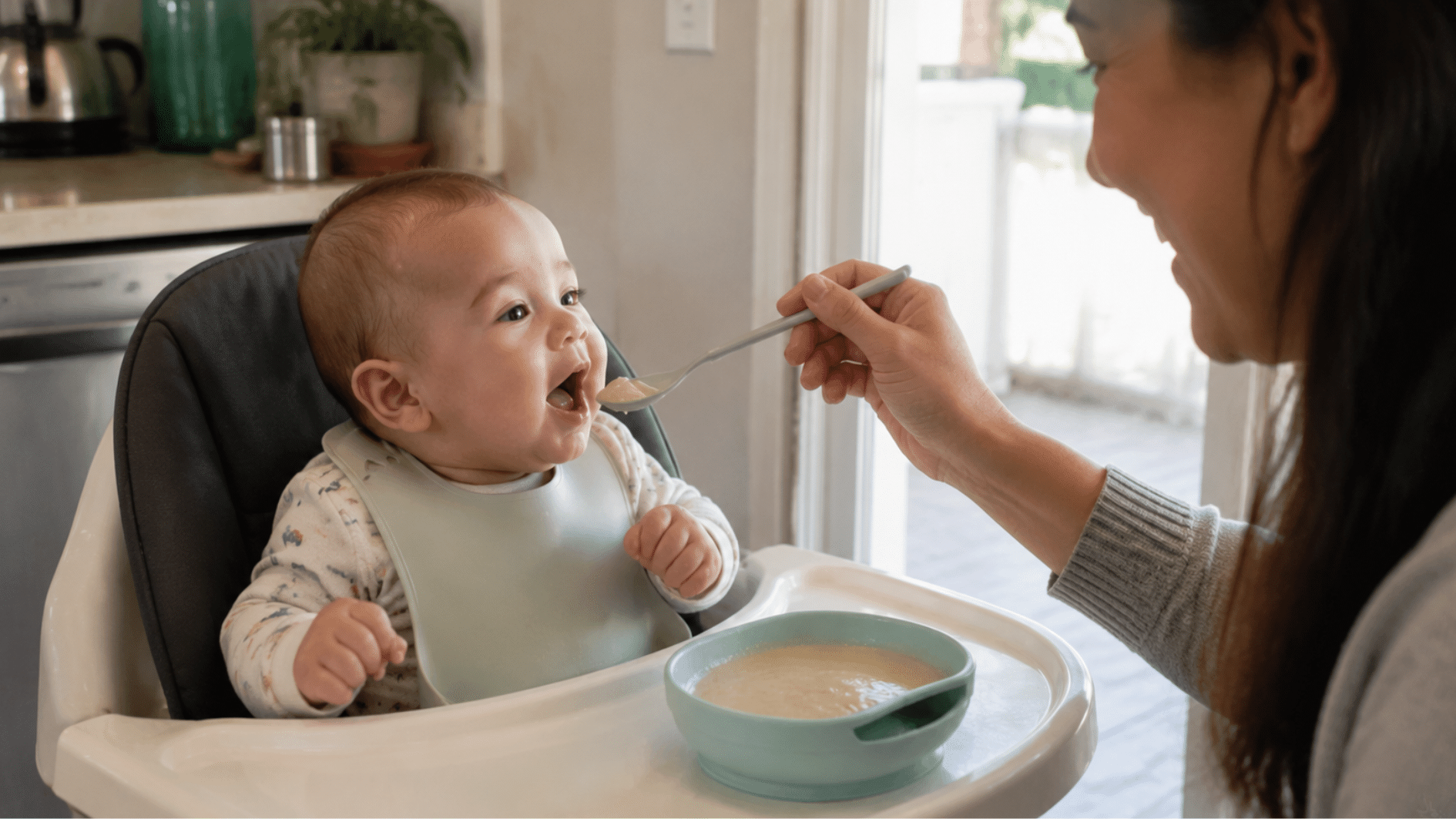 parent feeding baby cereal with a spoon while the baby sits in a high chair