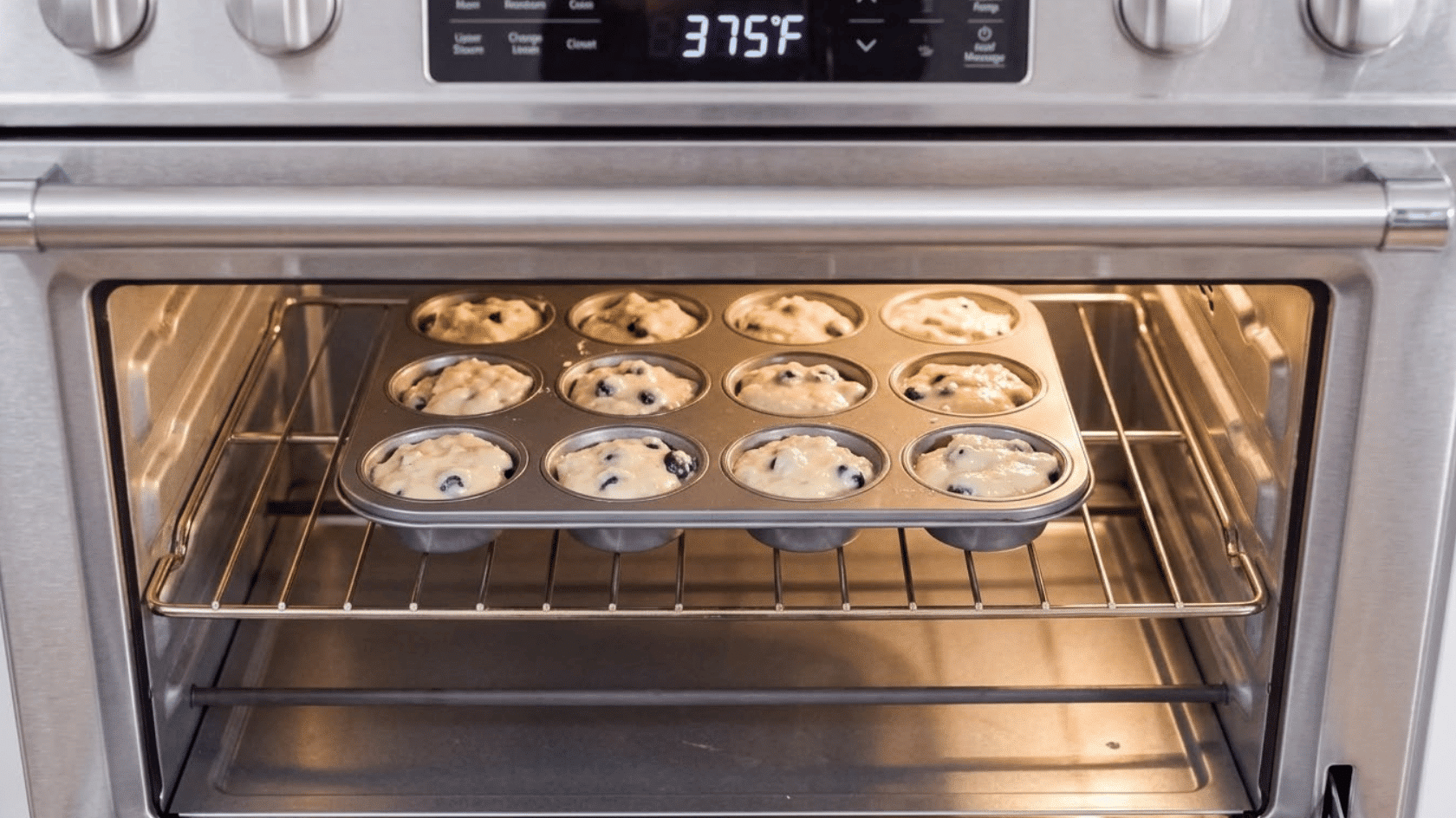 banana chocolate chip muffins baking in a muffin tin inside an oven