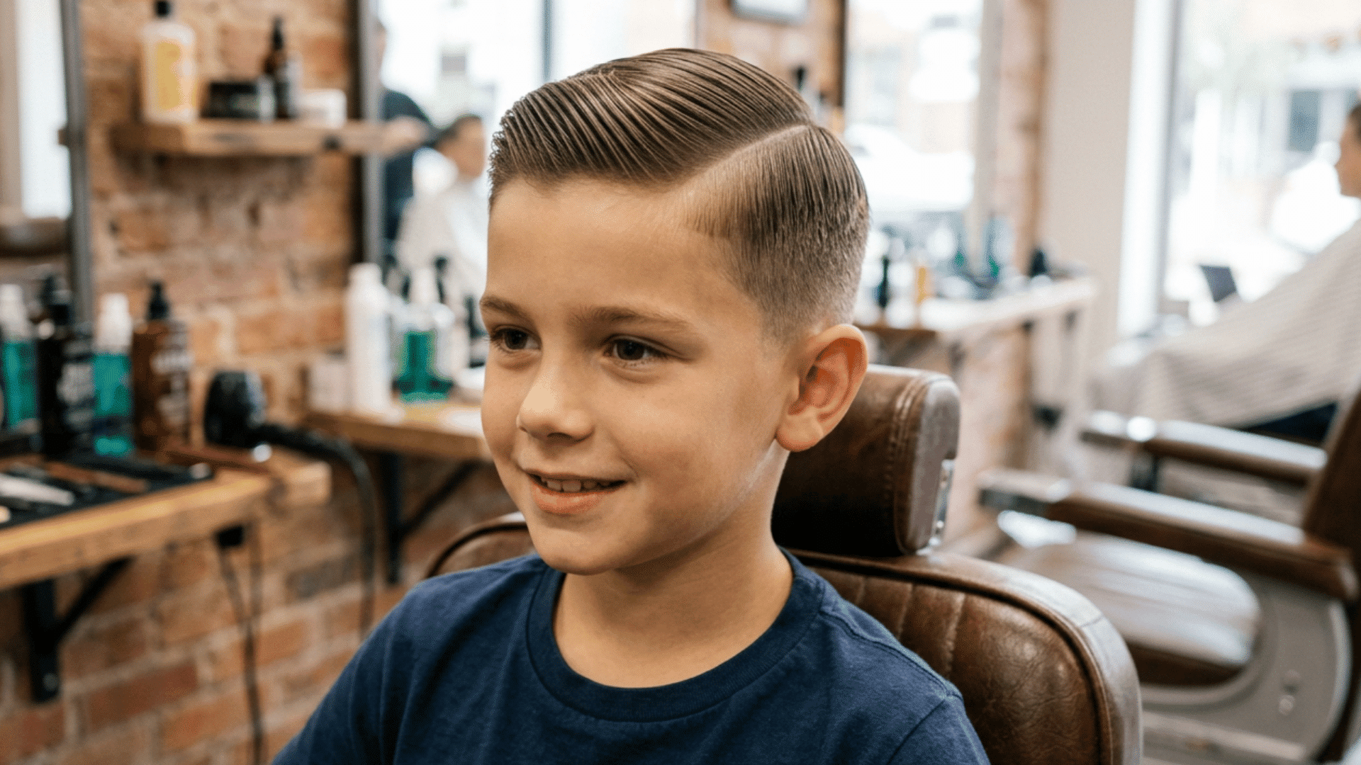 boy with a crew cut and slicked side part with neat short sides in a realistic indoor setting