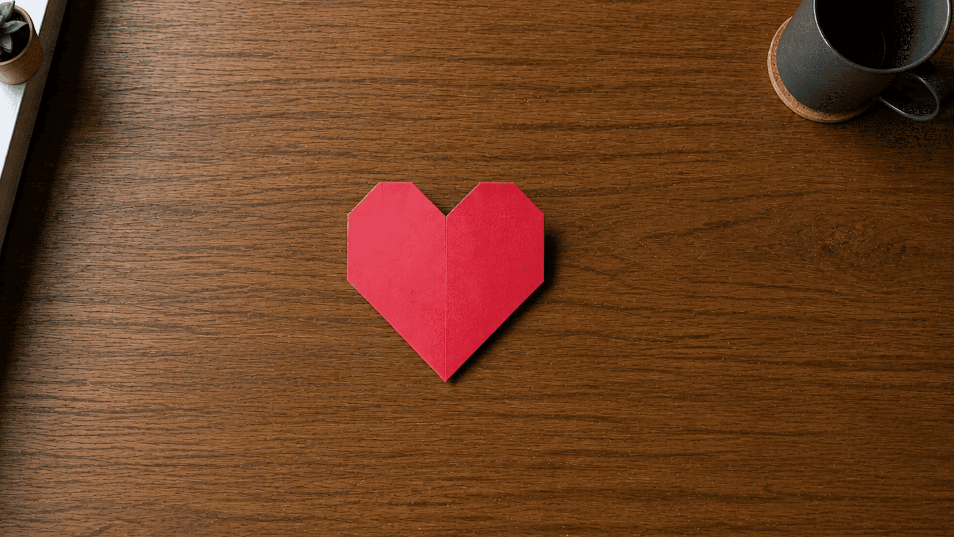 finished red paper heart shape from an origami folding tutorial