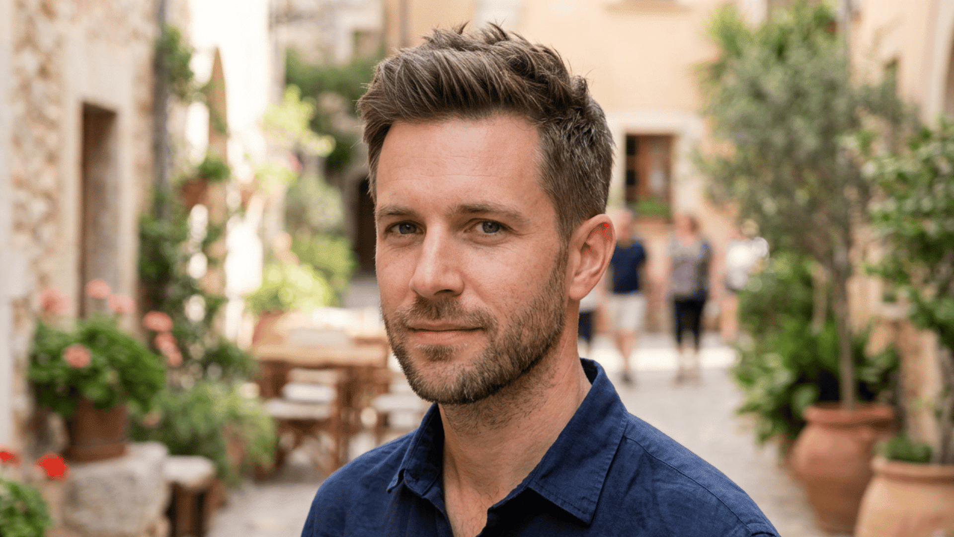 man with an oval face wearing a brushed up short crop with moderate volume