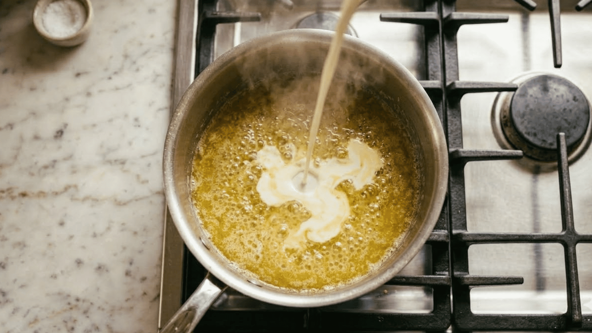 butter melting into heavy cream in a saucepan for alfredo sauce
