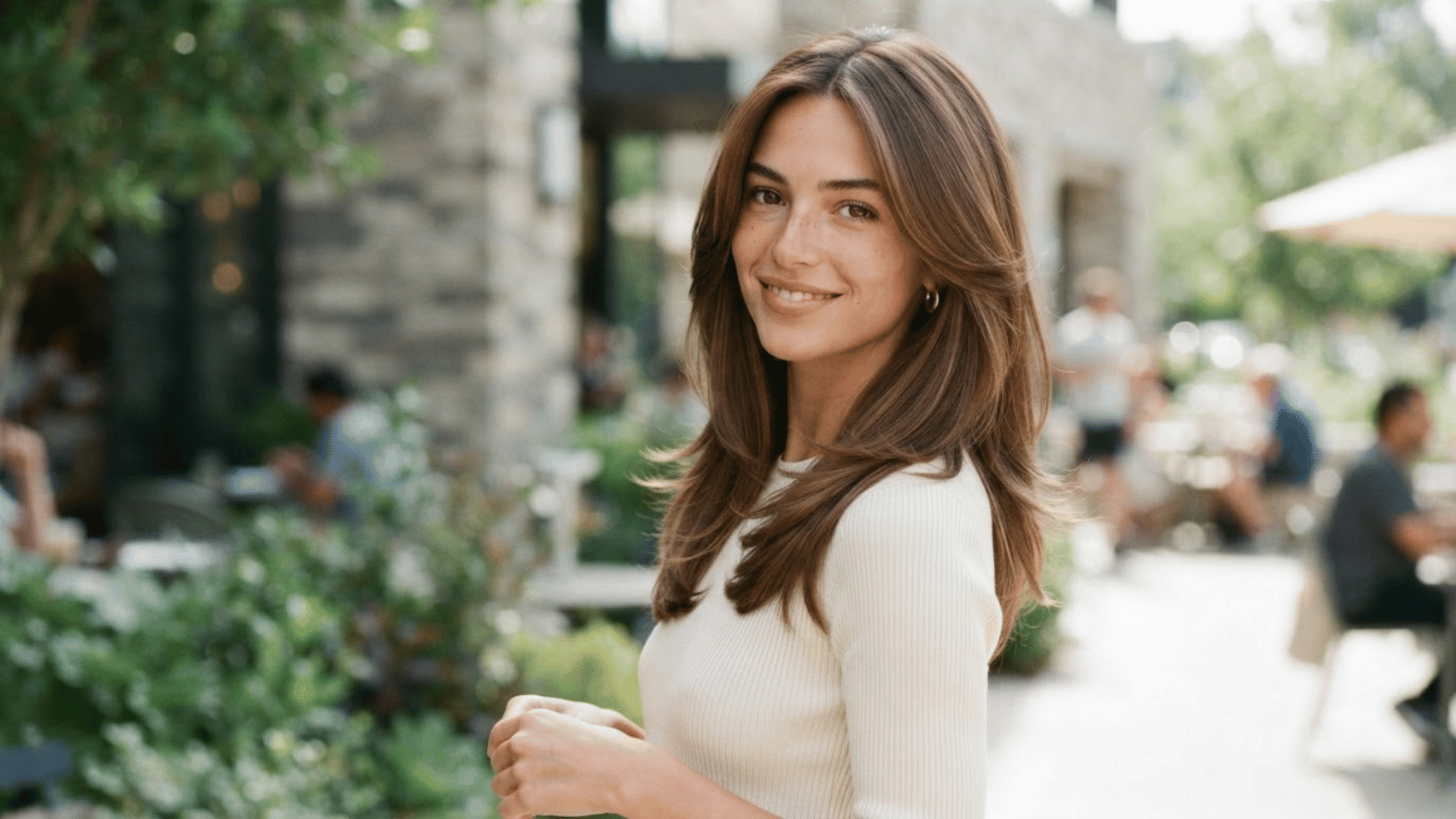 shoulder length haircut with long layers and soft face framing pieces styled outdoors with natural movement hair