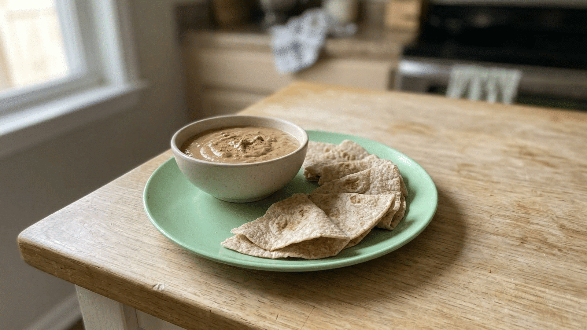 smooth bean dip served with small pieces of soft whole-grain tortilla