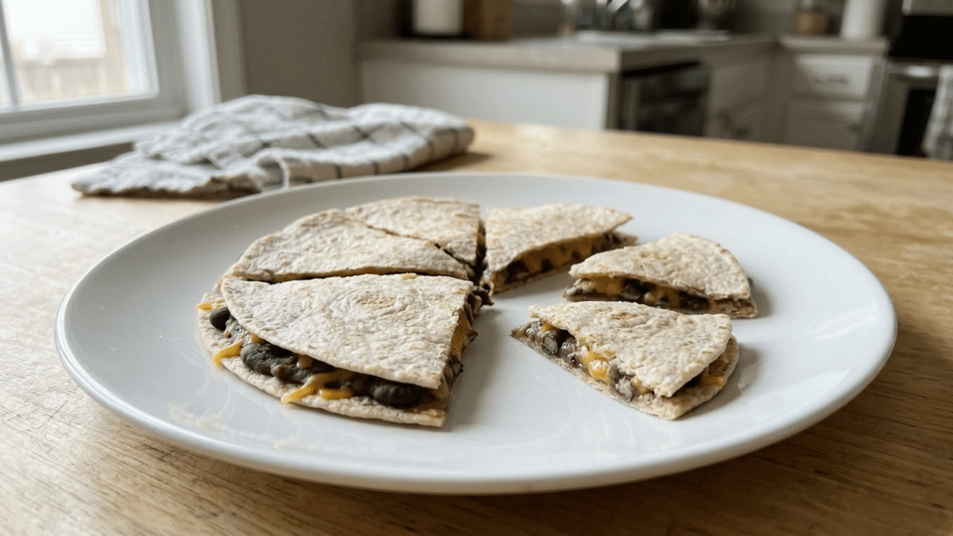 soft black bean and cheese quesadilla cut into toddler-sized pieces
