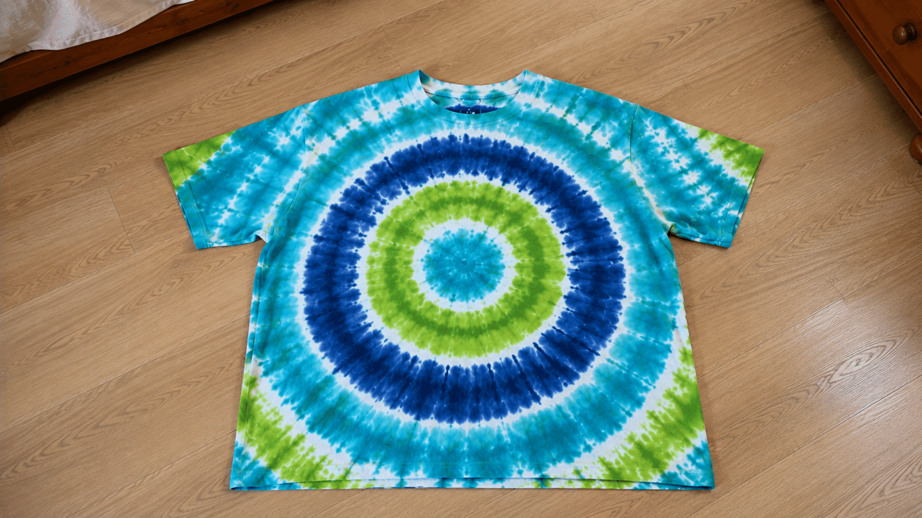 blue and green bullseye tie dye pattern on a cotton t shirt
