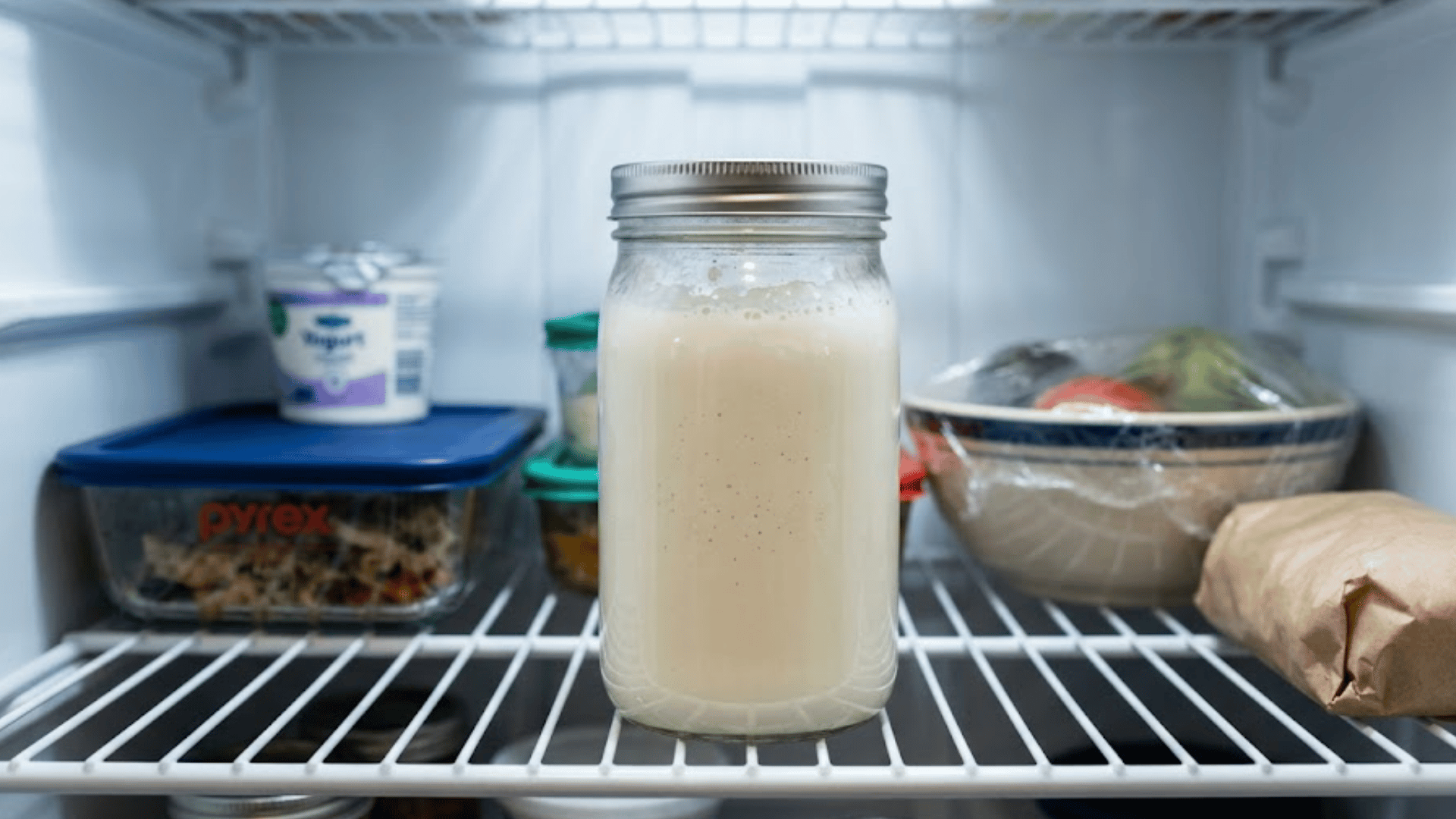 glass jar of homemade buttermilk sealed with a lid and stored on a clean refrigerator shelf for freshness