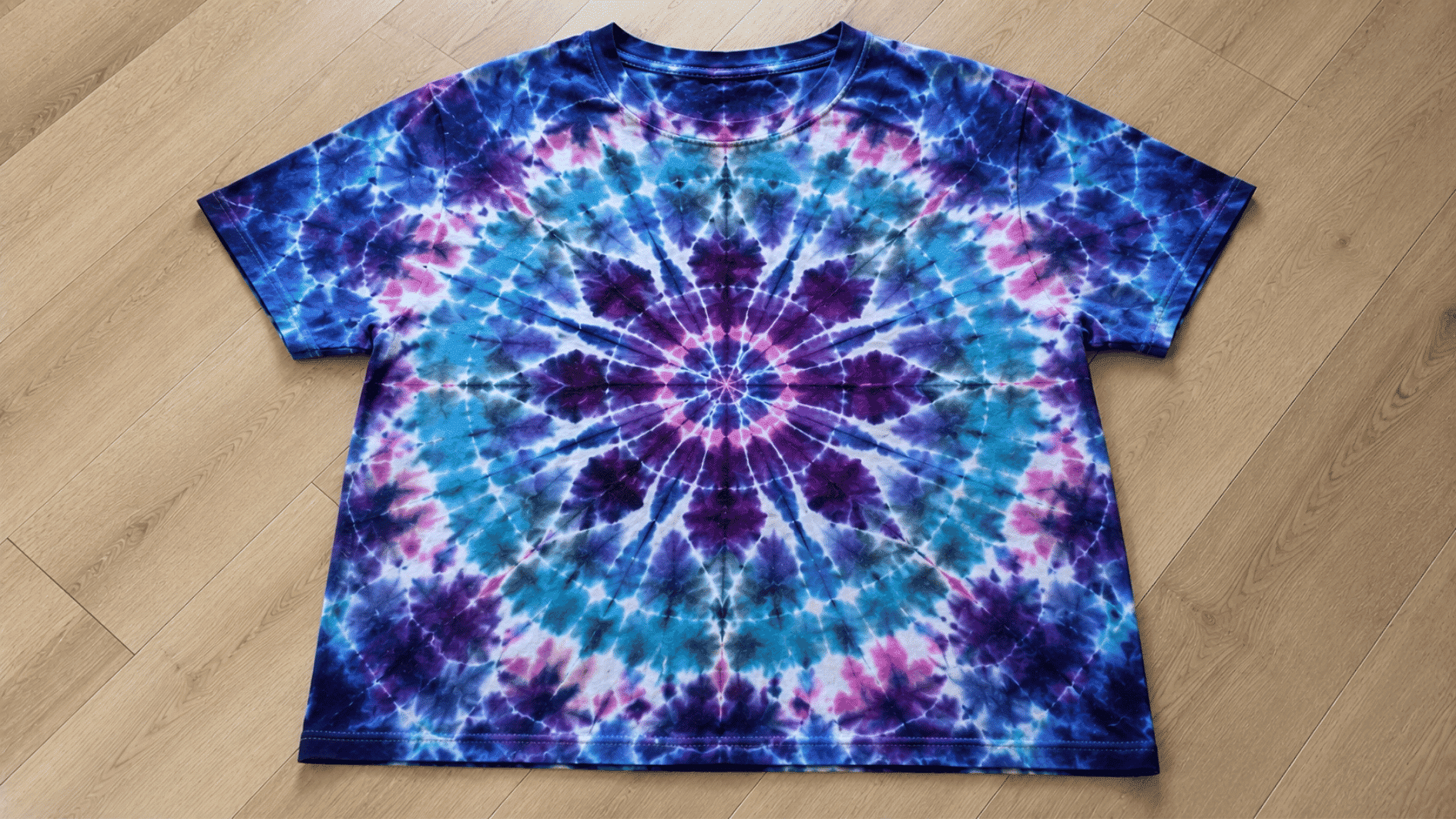 detailed purple and blue mandala tie dye pattern on a cotton t shirt