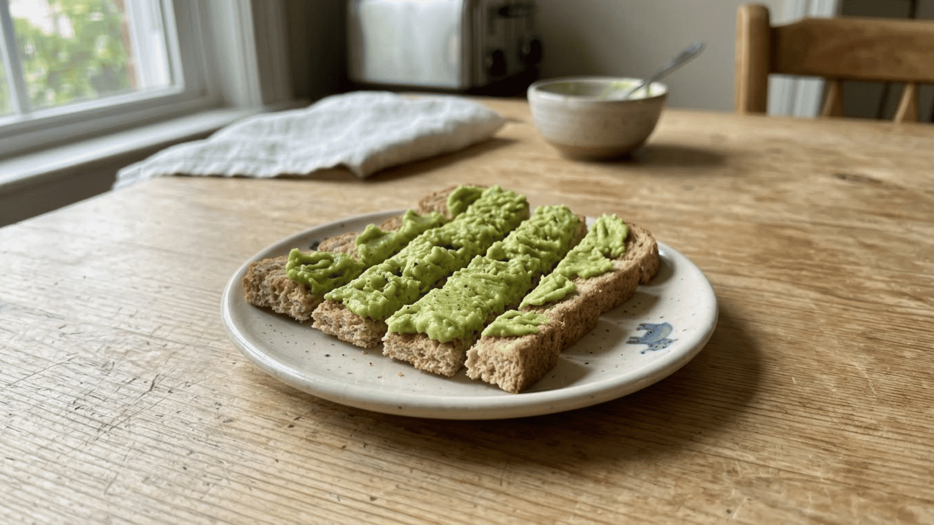 avocado spread on whole-grain toast strips served as a high-fiber toddler snack