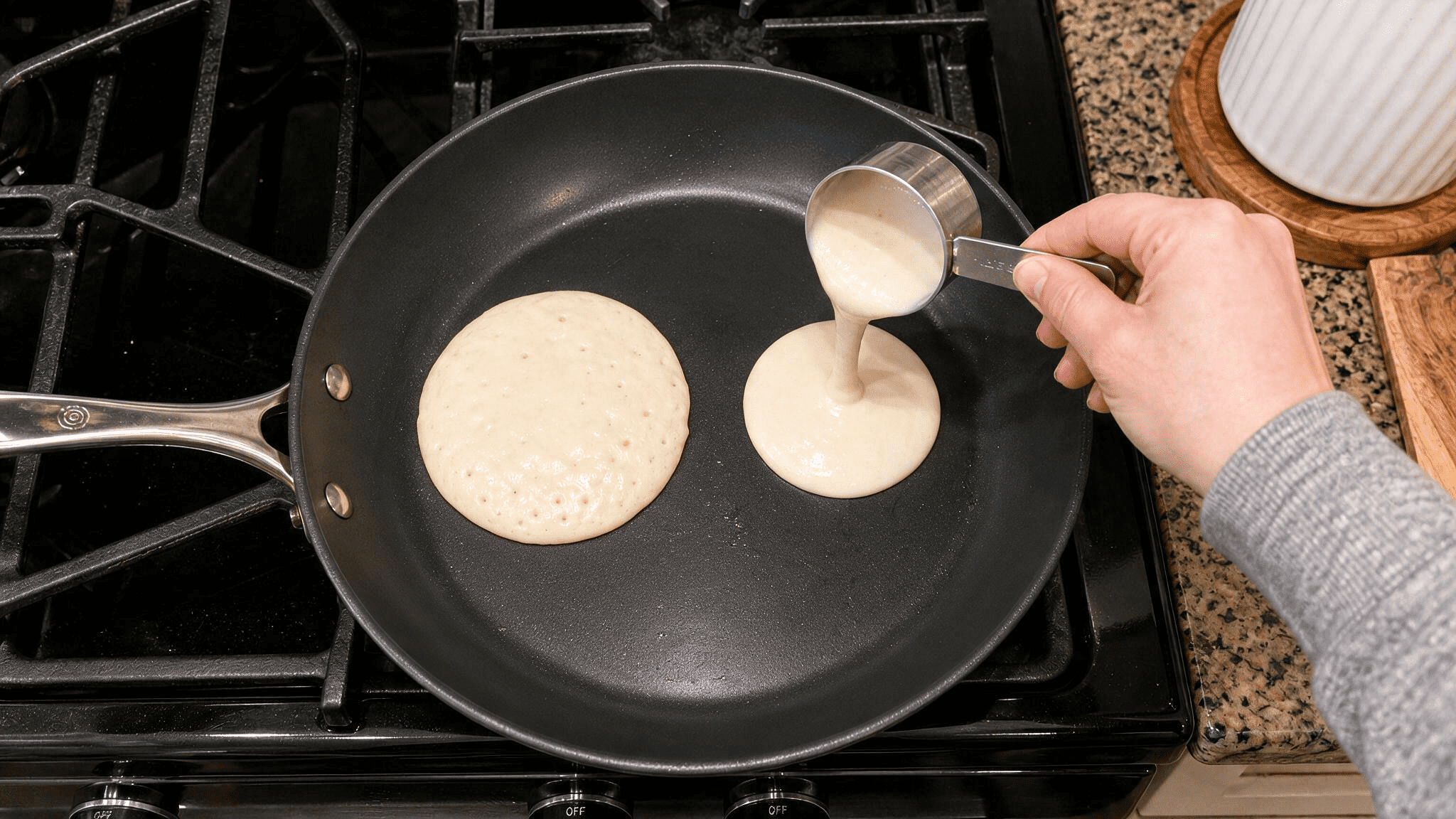 quarter cup of batter poured onto a warm skillet to form a pancake.