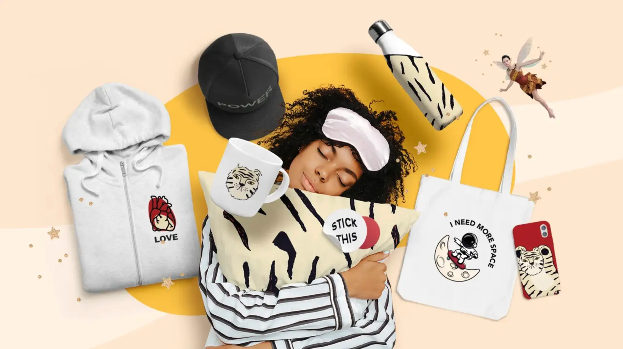 Person sleeping on striped pillow surrounded by merchandise, including hoodie, cap, and tote bag
