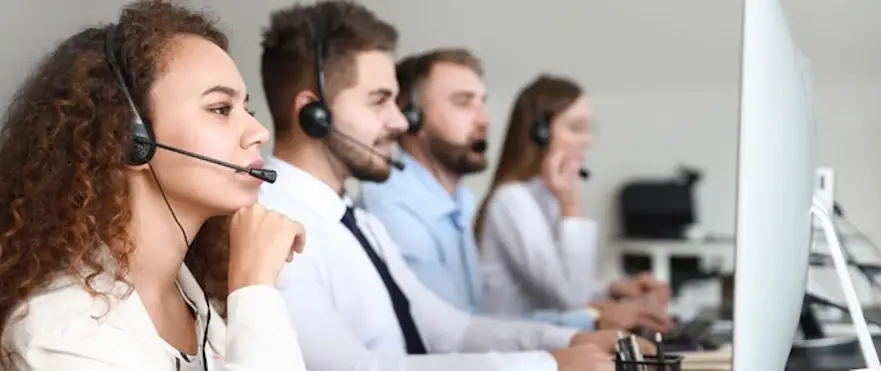 Customer service representatives with headsets working in a modern office setting